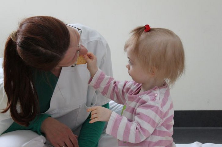 Kleinkind füttert Therapeutin