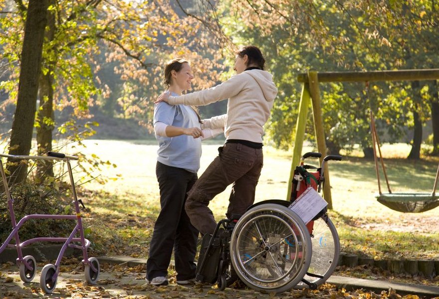 Junge Erwachsene mit Therapeutin im Klinikgarten